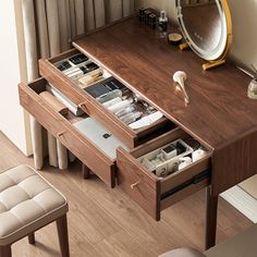 a wooden desk with drawers underneath a mirror