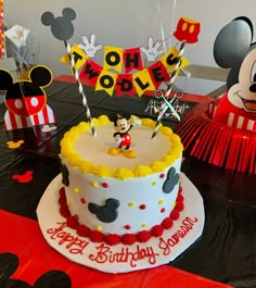 a mickey mouse birthday cake on a table