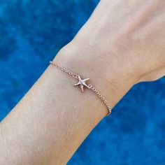 Our Capeology starfish bracelet represents change and growth. Starfish are known for renewal and self-sustainability. Wear this bracelet and you'll always remember to trust your instincts and explore new possibilities and opportunities. This piece is made out of sterling silver and is complete with a lobster claw clasp. The chain is adjustable and has the option to be worn at 7.0, 7.5, or 8.0 inches in length. The back of the bracelet is engraved with "CAPEOLOGY." Proudly made in the USA. Keep y Minimalist Starfish Jewelry Gift, Starfish Charm Bracelet As A Gift, Starfish Charm Bracelet As Gift, Starfish Charm Bracelet Gift, Adjustable Starfish Charm Bracelet Gift, Silver Starfish Bracelet For Gift, Adjustable Starfish Charm Jewelry, Adjustable Starfish Bracelet With Lobster Clasp, Silver Starfish Bracelet