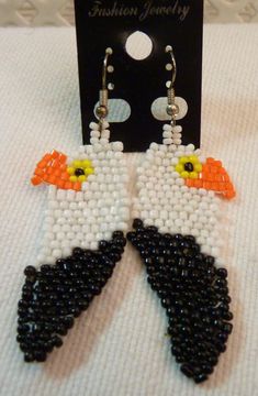 This is a pair of hand beaded earrings, so they are unique on their own. They have stainless steel ear wires and silicone backs. These are very striking and would make a lovely gift for that special person on your list. These earrings have been produced in a smoke free environment. Gift White Beaded Earrings With Black Beads, Unique Black Beaded Earrings As Gift, Unique Black Beaded Earrings For Gift, Black Beads Dangle Earrings Gift, Black Beaded Dangle Earrings Gift, Black Beaded Dangle Earrings For Gifts, Unique White Jewelry With Black Beads, Gift Earrings With Round Black Beads, White Beads With Ear Wire For Jewelry Making