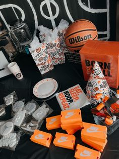 an orange and white basketball is on display with other sports related items, including candy