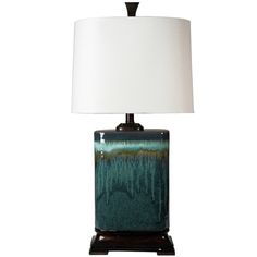 a table lamp with a white shade on it and a black base in front of a white background