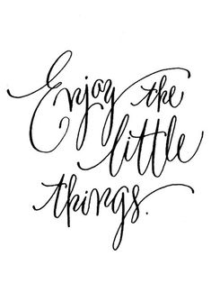 the words enjoy the little things written in cursive writing