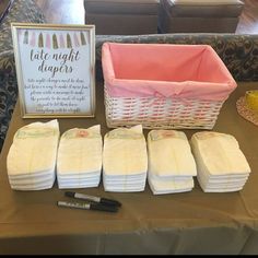 baby diapers are laid out on a table next to a basket and sign that says late night diapers