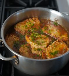 a pan filled with food sitting on top of a stove