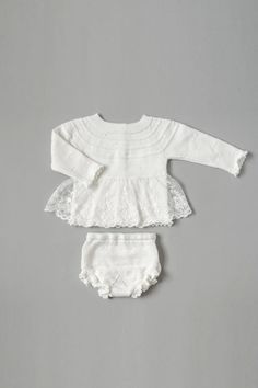 Introducing our Vintage Gorgeous Knitted Dress 2-Piece Set in a timeless Off-White hue! The knitted top, adorned with an embroidered lace skirt, boasts an enchanting vintage-inspired charm. Delicate scallops grace the edges of the long sleeves and the bottom of the top, while the knitted bloomer echoes this elegance with its own scalloped details. Designed for little ones from 0 months to 2 years, this ensemble captures the essence of vintage beauty with a modern twist. The off-white color adds Cream Lace Fitted Sets, Fitted Cream Lace Sets, Fitted White Sets With Lace Trim, White Fitted Sets With Lace Trim, Fitted White Set With Lace Trim, Fitted Vintage Sets With Lace Trim, Fitted Vintage Set With Lace Trim, Fitted Lace Trim Sets For Daywear, Fitted Lace Trim Set For Baptism