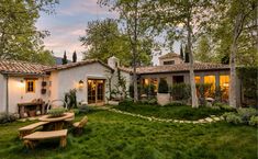 a white house with a picnic table in the front yard