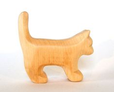 a wooden toy cat on a white background