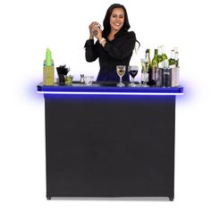 a woman standing behind a bar with bottles and glasses on it