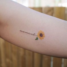 a small sunflower tattoo on the arm that says, i love you more than me