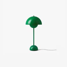 a green table lamp on a white background