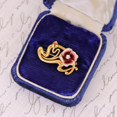 This 14k gold antique brooch (circa 1910) features a flower of dark pink and white enamel with a diamond accent. The reverse bears the makers mark for the renowned Krementz & Co of Newark New Jersey. The piece measures 0.6 inches by 1 inch wide, and it is in great condition. Note: The antique box depicted in the photo is for display purposes only and is not included with the brooch. We have many other fantastic offerings of antique and vintage jewelry posted on our Etsy store, so please consider Yellow Gold Enamel Brooches Hallmarked, Hallmarked Enamel Brooches As Gifts, Hallmarked Enamel Brooches For Gifts, Victorian Enamel Brooches For Formal Occasions, Victorian Enamel Brooches For Formal Wear, Victorian Style Enamel Brooches For Formal Occasions, Elegant Flower Enamel Pin Collectible, Elegant Yellow Gold Enamel Pin Gift, Gift Enamel Brooches Hallmarked