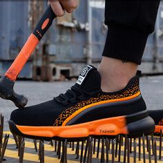 a person with an orange shoe brush on top of some metal spikes in the street