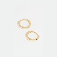 Pure and minimalist, though small, these huggies are impactful in polished gold. Comfortable enough to sleep in, with an easy to wear hinge closure. Vermeil, a thick 18K gold layer on top of sterling silver. Tarnish resistant. Length: 0.4in/10mm Everyday Huggie Hoop Earrings, Gold Huggie Earrings For Everyday, 14k Gold Minimalist Huggie Earrings, Adjustable 14k Gold Minimalist Huggie Earrings, Simple Adjustable Huggie Earrings For Everyday, Simple Gold Huggie Earrings Tarnish Resistant, Simple Gold Huggie Hoop Earrings, Simple Gold Small Hoop Huggie Earrings, Gold Hinged Huggie Earrings