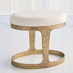 a round stool with a white cushion on the top and gold metal frame around it