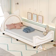 a white bed sitting on top of a wooden floor