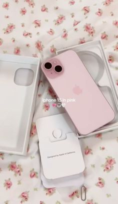 the pink iphone 11 is in its box and next to it's packaging contents