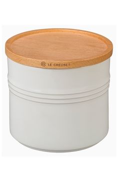 a white container with a wooden lid