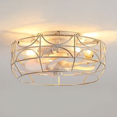 a ceiling light that is hanging from the ceiling and has white lights on top of it