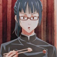 a person with glasses holding chopsticks in their hands