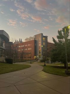 an empty sidewalk in front of a large building