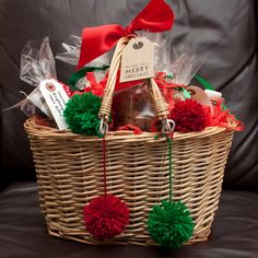 a basket filled with lots of different items on top of a couch next to a pillow