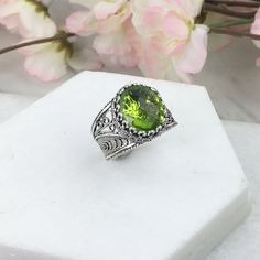 925 Sterling Silver Oval Filigree Ring with Peridot Doublet Quartz Natural Gemstone  Material: 925 Solid Sterling Silver, Peridot Gemstone Gemstone Dimensions: 12 mm x 10 mm, Oval, Faceted Ring Face Length: 0.60 inch   Ring Face width: 0.50 inch This will come in a designer pouch & gift box  Free Domestic Shipping  It is a gift that will create memories for years to come. Our fine silver jewelry is Made in our exclusive Artisan workshops in Turkey. Our aim is to exceed all the expectations that Green Oval Engraved Rings, Green Oval Filigree Ring In Sterling Silver, Handmade Oval Peridot Rings, Green Filigree Ring As Fine Jewelry Gift, Green Filigree Ring Fine Jewelry For Gift, Silver Leaf Art, Faceted Ring, Fine Silver Jewelry, Oval Ring