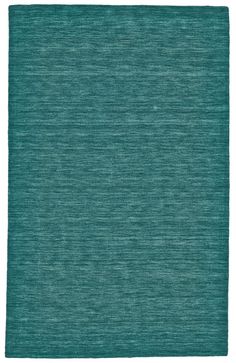 a green rug with an uneven design on the front and back side, in shades of teal