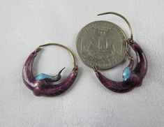 A gorgeous pair of cloisonne arched crane earrings in vermeil (gold wash), with purple and turquoise blue enamel. Probably early Laurel Burch earrings - if you know how to verify (or not), I'd love a convo! In good to very good condition - just gently used and loved - a few small deformities here and there but no loss of enamel or function. For items shipped to places outside of the US, buyers pay all costs related to the import of the items, including customs fees and taxes. Purple Pierced Metal Jewelry, Purple Vintage Jewelry, Collectible Enamel Jewelry With Matching Earrings, Purple Metal Pierced Jewelry, Nickel Free Enamel Hoop Jewelry, Pierced Enamel Drop Earrings, Enamel Ear Wire Jewelry, Bohemian Enamel Jewelry, Vintage Pierced Enamel Jewelry