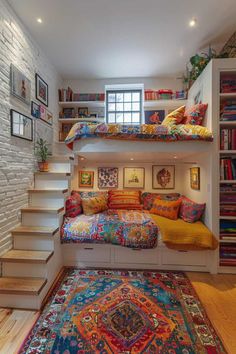 a room with some bookshelves, stairs and a rug on the floor in front of it