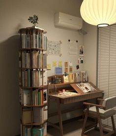 a room with a desk, chair and bookshelf full of books on it