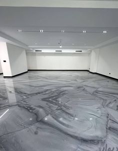 an empty room with marble floors and white walls