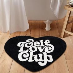 a bathroom rug with the words self love club on it