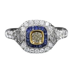 Brilliant Art Deco Style Ring. 18k White Gold 5.90 grams. Total all Diamonds 1.18 carat (center stone is cushion light Yellow diamond 0.31 carat)arround it - Blue sapphire total 0.35carat (baguettes) overall design area size on the top is 11 x 11 mm. Finger size 7. diamond are GH-SI Luxury Multi-stone Yellow Diamond Ring, Luxury Multi-stone Cushion Cut Ring, Luxury Multi-stone Cushion Cut Jewelry, Luxury Cushion Cut Multi-stone Jewelry, Luxury Yellow Gold Sapphire Cushion Cut Ring, Anniversary Multi-stone Cushion Cut Jewelry, Anniversary Cushion Cut Multi-stone Jewelry, Luxury Cushion Cut Halo Ring, Cushion Cut Multi-stone Jewelry For Anniversary