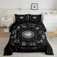 a black bed with zodiac signs on it