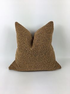 a brown pillow sitting on top of a white table