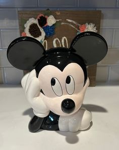 a mickey mouse figurine sitting on top of a counter