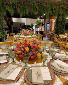 a table set with place settings and flowers