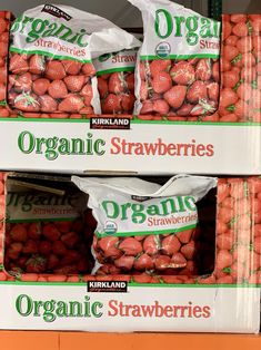 two packages of organic strawberries are stacked on top of each other