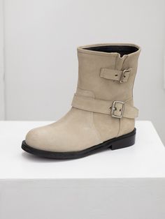 Editor's NotesTWVP presents handmade feminine shoes with high-quality materials and modern mood.- Biker ankle boots- Buckled strap detail- Soft suede leather- Non-slip outsole detail - Easy slip-on designMeasurements(in.)- Size: KR 225MM (US 5.5) - KR 255MM (US 8.5)- Heel Height: 0.8 in.*Fits true to the size <235MM(US6.5)>- Shaft length: 6.7 in. - Ankle/Opening Circ.: 13.4 in. Composition & Care- Cow Leather- Lining: Synthetic Leather- Insole: Synthetic Leather- Avoid d Beige Leather Moto Boots With Round Toe, Moto Boots With Buckle Closure And Flat Heel, Beige Leather Ankle Moto Boots, Winter Suede Moto Boots With Buckle Closure, Beige Ankle Boots With Buckle Closure, Beige Leather Boots With Buckle Closure, Suede Ankle Moto Boots With Buckle Closure, Suede Moto Boots With Buckle Closure Ankle Boot, Suede Moto Boots With Buckle Closure And Round Toe