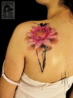 a woman with a pink flower tattoo on her shoulder