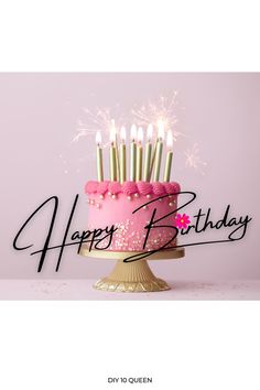 a pink birthday cake with sparklers on it and the words happy birthday written in black