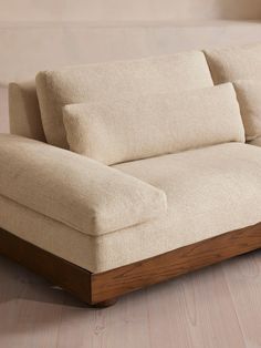 a white couch sitting on top of a wooden floor