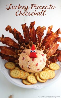 a turkey pimentoo cheeseball on a plate with crackers