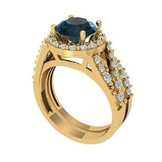 a gold engagement ring with a blue stone and white diamonds on the side, set in 18k yellow gold