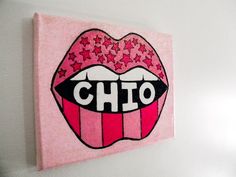 a pink wall hanging with the word chio painted on it's lips and stars