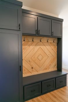 an empty room with some cabinets and drawers on the wall next to it is a wood floor