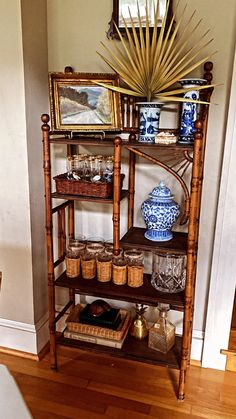 a wooden shelf with baskets and vases on it