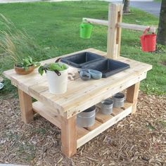 a potting bench made out of pallet wood with pots on it and plants in the background