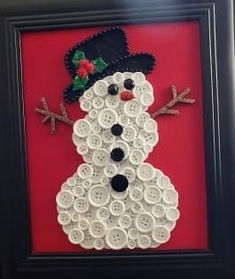 a snowman made out of buttons in a black frame on a red background,